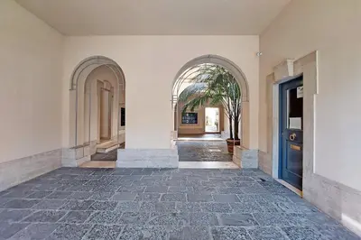 an empty hallway with an arcade and a blue door at MM Luxury Apartment in Rome