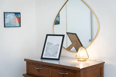 a mirror on top of a dresser with a lamp at Campani by Rental in Rome in Rome