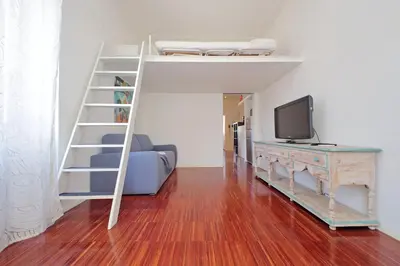 a bedroom with a bunk bed with a tv and a desk at 4BNB - Angelo Emo in Rome