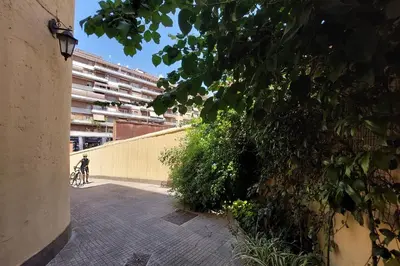 a person riding a bike down a sidewalk next to a building at 4BNB - Angelo Emo in Rome
