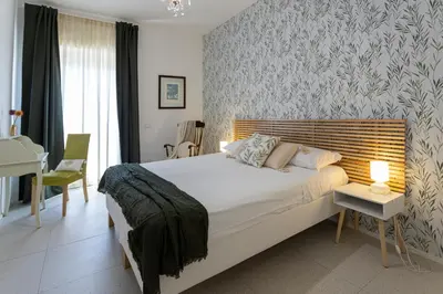 a bedroom with a bed and a table and a desk at Carlotta Stylish Apartment Close Tiburtina Station in Rome