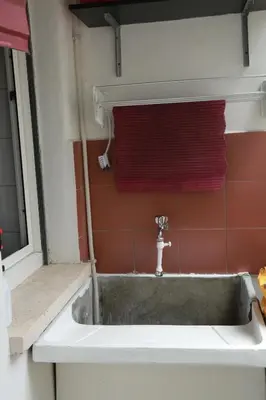 a sink in a bathroom with a window and red towels at Laura's Apartment Vatican in Rome