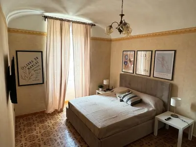 a bedroom with a large bed and a window at Campani Termini Apartment in Rome