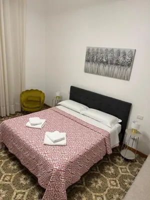 a bedroom with a bed with two towels on it at LarisaSuite in Rome