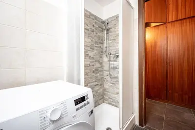 a bathroom sink with two soap dispensers and a mirror at Dream suite Modern in Rome Air Conditioning WiFi near the Metro A in Rome