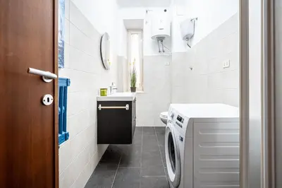 a bathroom with a washer and dryer in it at Dream suite Modern in Rome Air Conditioning WiFi near the Metro A in Rome