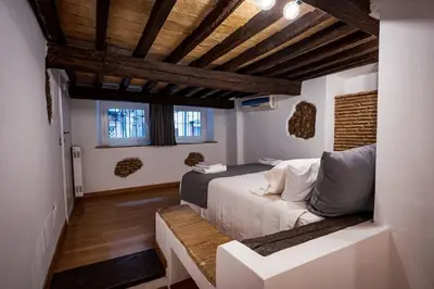 a bedroom with a bed in a room with wooden ceilings at Pantheon Appartamento Costaguti in Rome