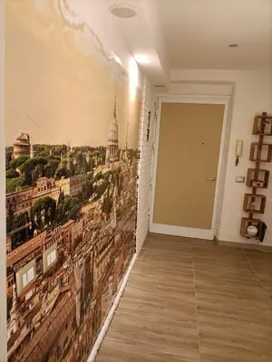 a room with a wall mural of a city at A bridge to the Coliseum in Rome