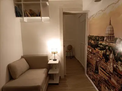 a living room with a couch and a painting on the wall at A bridge to the Coliseum in Rome