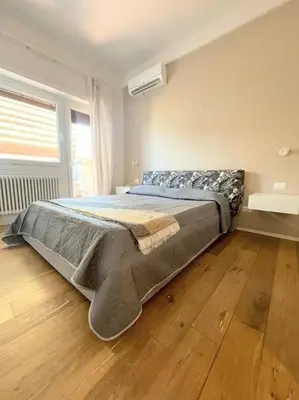 a bed in a bedroom with a wooden floor at MilleStorie House Rome in Rome