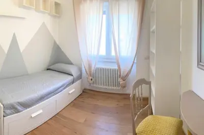 a small bedroom with a bed and a window at MilleStorie House Rome in Rome