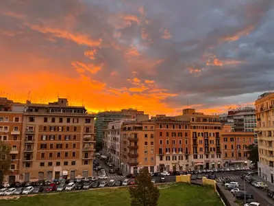 a city with cars parked in a parking lot at Sunrise House - San Giovanni in Rome