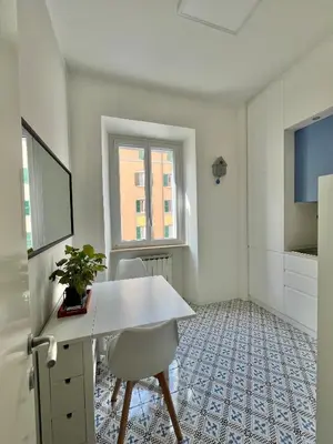 an empty room with a white desk and a window at Sunrise House - San Giovanni in Rome