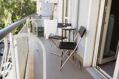 a balcony with two chairs and a table at Two Bedroom Appartment - 3 min Metro Conca D'Oro by ORPI RENT in Rome