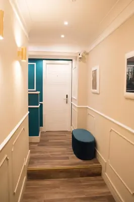 a hallway with a door and a stool at Le Petit Bijou in Rome