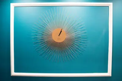 a clock in a frame on a blue wall at Le Petit Bijou in Rome
