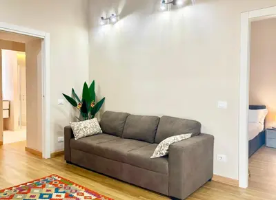 a living room with a couch and a rug at DaliTourism - Nazionale Charme in Rome