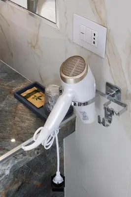 a hair dryer sitting on a counter in a bathroom at Caruso Regal House in Rome