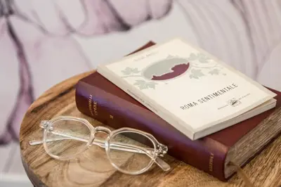 a pair of glasses sitting on top of two books at Re di Roma Luxury Suite in Rome