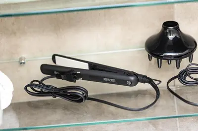 a black remote control on a glass table at Fabiè Trastevere in Rome