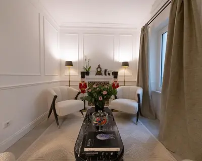 a living room with a coffee table and two chairs at La Scalinata - Boutique Guest House in Rome