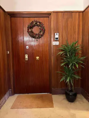 a wooden door with a plant in front of it at La Scalinata - Boutique Guest House in Rome