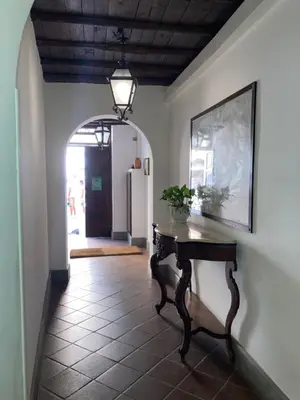 a hallway with a table and a picture on the wall at Appartamento storico borgo Pio in Rome