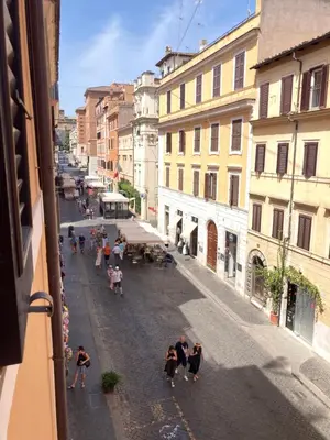a group of people walking down a city street at Appartamento storico borgo Pio in Rome