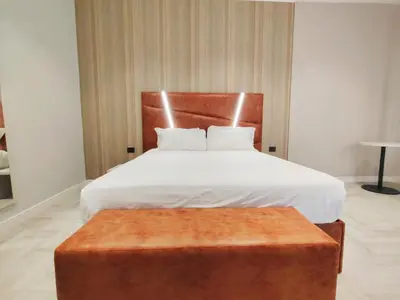a bedroom with a large bed with a wooden headboard at Crystal Domus in Rome