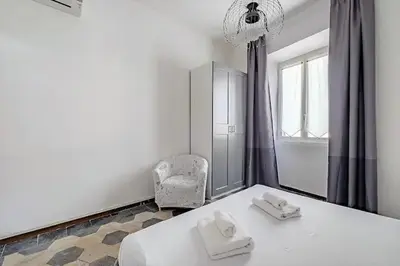 a bedroom with a bed and a chair and a mirror at Apartment B4 in the center of Rome WiFi and AC in Rome