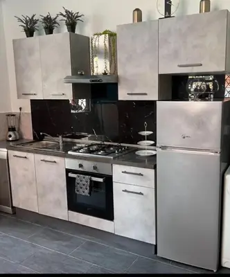 a kitchen with a stove and a refrigerator at Casa vacanze San Lorenzo in Rome