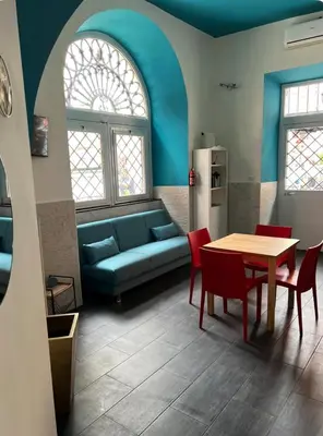 a living room with a couch and a table and chairs at Casa vacanze San Lorenzo in Rome