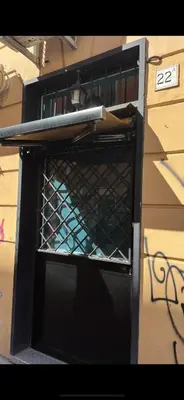 an open oven with a metal rack on the side of a building at Casa vacanze San Lorenzo in Rome