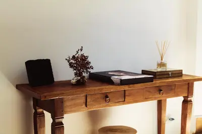 a wooden table with books and other items on it at Domus Duca Claudius I Classy Vatican Apartment With Private Garden in Rome