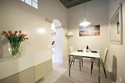 a dining room with a white table and chairs at Living Rhome-SpanishSteps in Rome