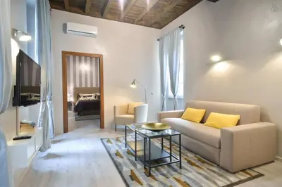 a living room with a couch and a table at Living Rhome-SpanishSteps in Rome