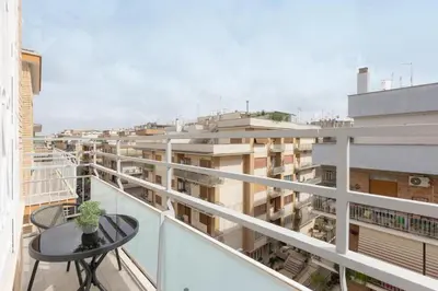 a balcony with a table and a view of buildings at Sweet Maya Home in Rome