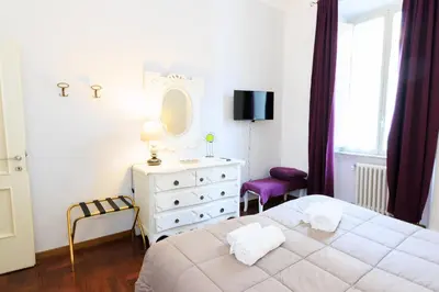 a bedroom with a bed and a dresser and a mirror at Vespasiano 49 in Rome