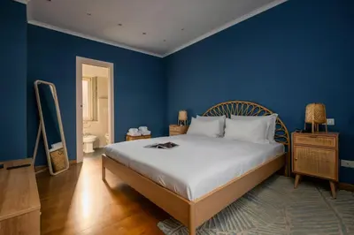 a bedroom with a large bed with blue walls at Da Giorgio e Teresa - Attico con terrazza a Piazza del Popolo in Rome