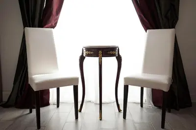 two chairs and a table in front of a window at Roman Holidays cuore dell'Impero in Rome