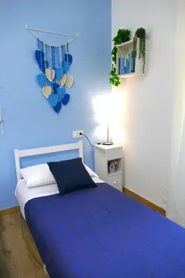 a blue bedroom with a bed and a blue wall at My Dream in Rome in Rome