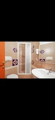 a bathroom with a sink and a toilet and a shower at Casa di Flavio a San Pietro in Rome