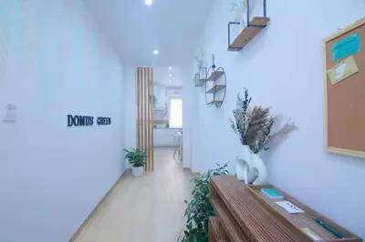 a hallway with blue walls and a wooden bench in a room at Domus green in Rome