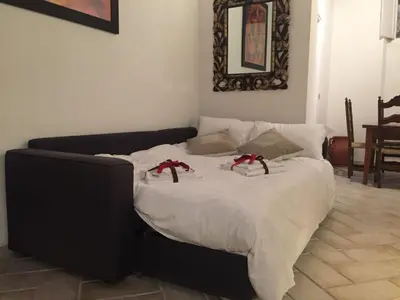 a bed with red bows on it in a room at B&S Suite Colosseo in Rome