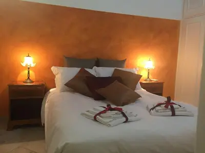 a bed with two towels on it with two lamps at B&S Suite Colosseo in Rome
