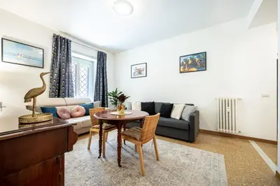 a living room with a table and a couch at King Size Apartment WiFi AIR CONDITIONING TV50 10MIN COLOSSEO-TRASTEVERE in Rome