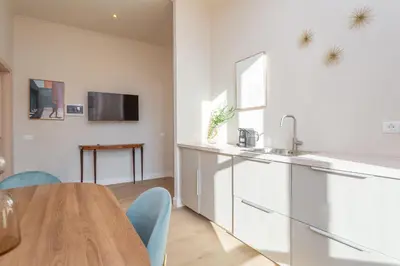 a kitchen and dining room with a table and a sink at Daplace - Romina Apartment in Rome