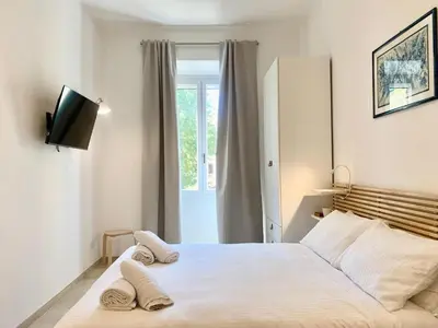 a bedroom with a bed with two towels on it at RomeAsYouLike - Stradivari Charme in Rome