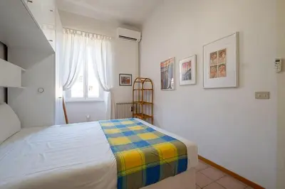 a bedroom with a bed with a colorful blanket on it at ht mama bilo vatican area in Rome
