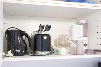 a coffee maker and other kitchen items on a shelf at ht mama bilo vatican area in Rome